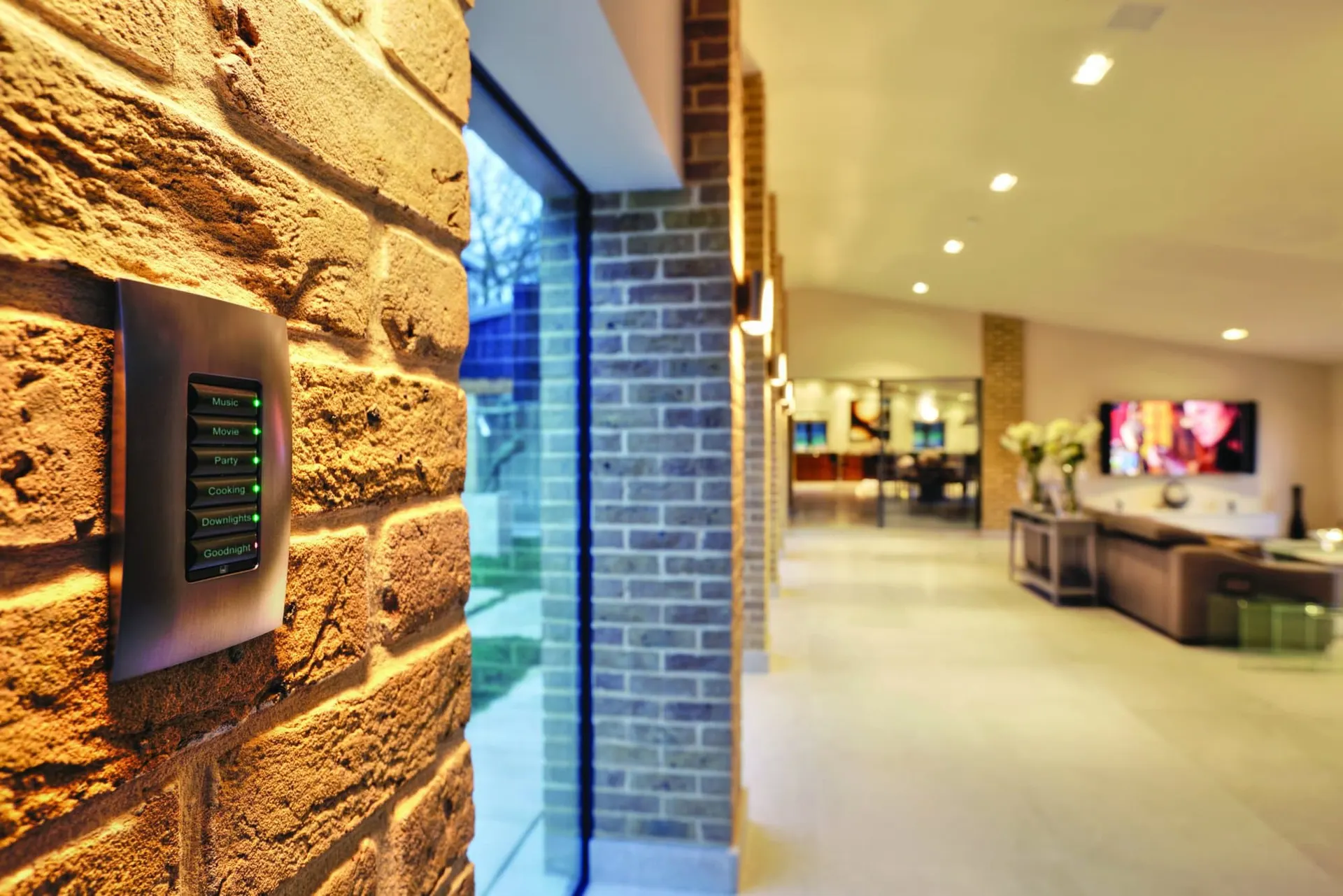 Engraved Control4 keypad on a brick wall